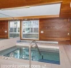 view of swimming pool with an indoor in ground hot tub