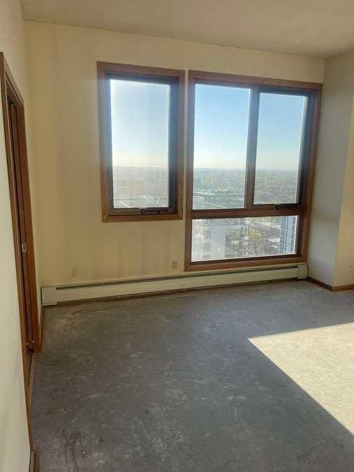 empty room featuring concrete floors and a baseboard radiator