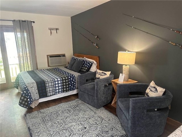 bedroom featuring wood finished floors and a wall unit AC