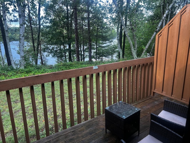 wooden terrace featuring a water view