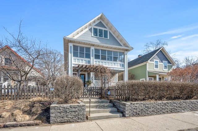 view of front of home featuring a porch and fence