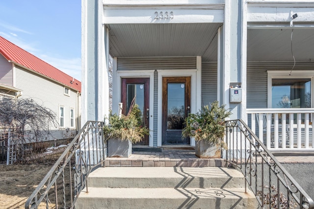 view of exterior entry with a porch