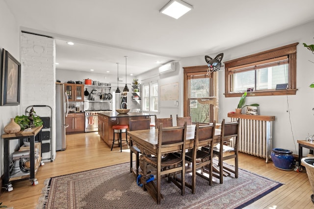 dining space featuring recessed lighting, light wood-style flooring, and a wall mounted AC