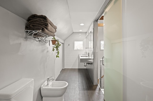 bathroom featuring toilet, wood finished floors, recessed lighting, a bidet, and vaulted ceiling