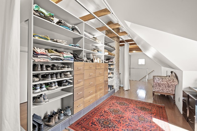 spacious closet featuring lofted ceiling and wood finished floors