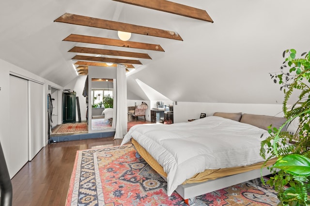 bedroom featuring vaulted ceiling with beams and wood finished floors