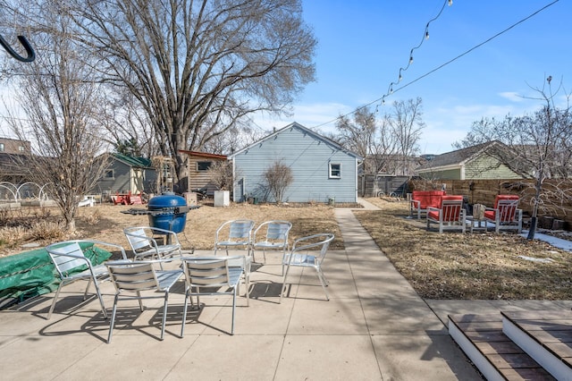 view of patio featuring a fire pit, area for grilling, and fence