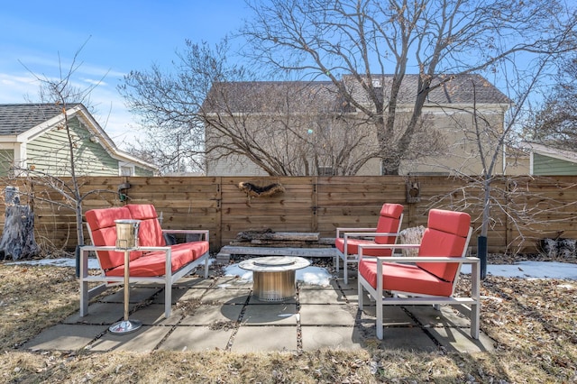 view of patio featuring a fenced backyard and a fire pit