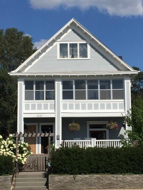 rear view of property with covered porch