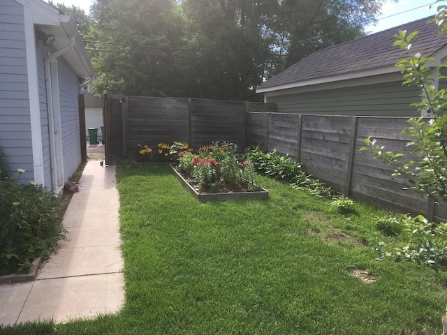 view of yard with a garden and fence