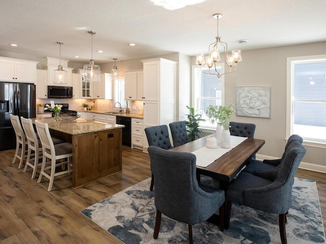 25338 Farmstead Ln, Wyoming, MN 55092 - dining room with dark wood-type flooring, baseboards, recessed lighting, and a notable chandelier