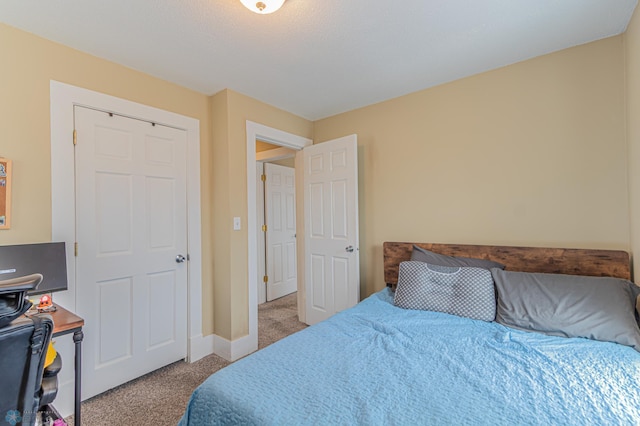 carpeted bedroom featuring baseboards