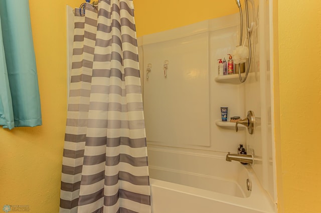 bathroom with shower / bath combo with shower curtain