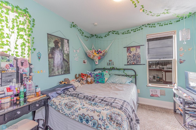 carpeted bedroom featuring baseboards