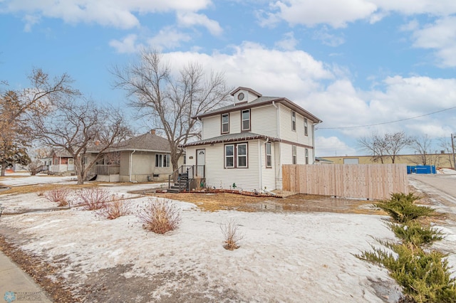 view of front of property featuring fence