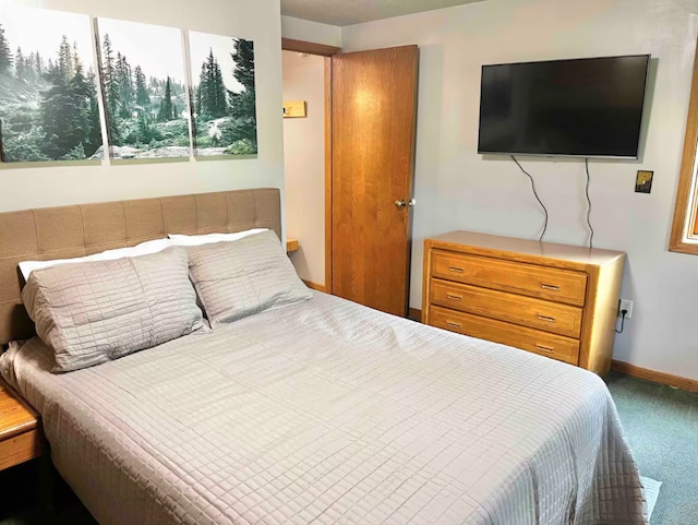 bedroom featuring carpet floors and baseboards