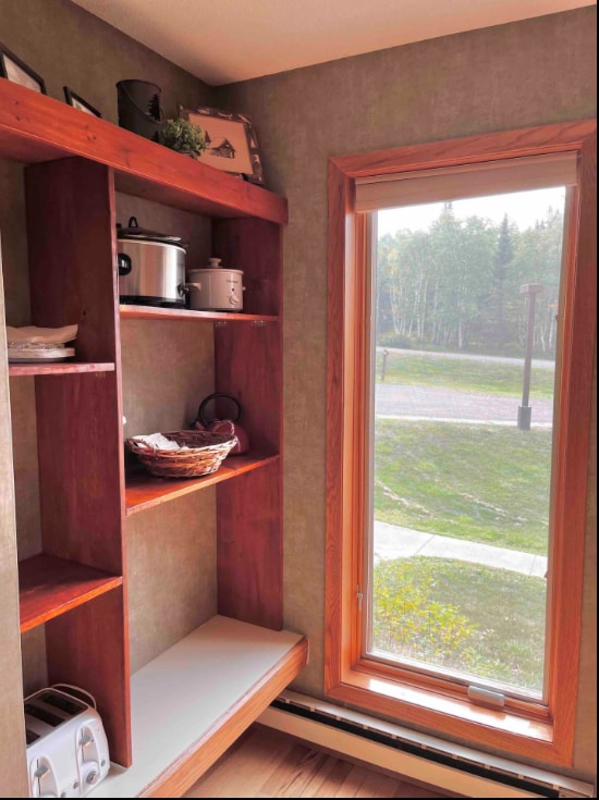 interior space featuring a baseboard radiator, a healthy amount of sunlight, and wood finished floors