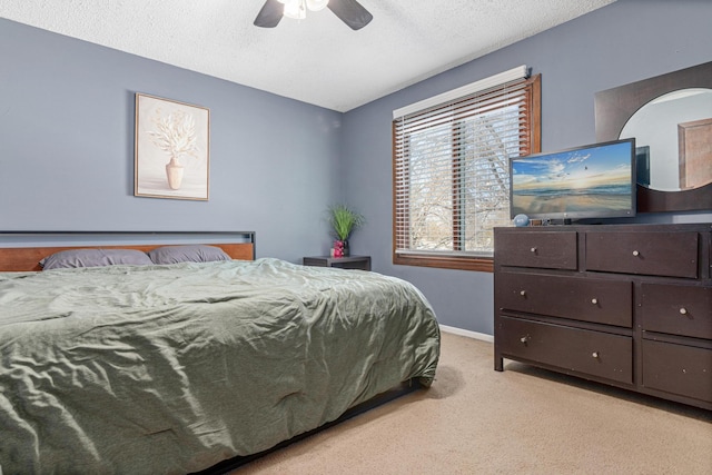 bedroom with carpet flooring, ceiling fan, a textured ceiling, and baseboards