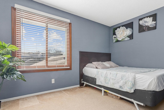 bedroom with carpet floors and baseboards