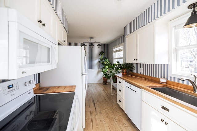 kitchen featuring a sink, wood counters, white appliances, white cabinets, and light wood finished floors