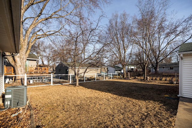 view of yard with cooling unit, a residential view, and fence