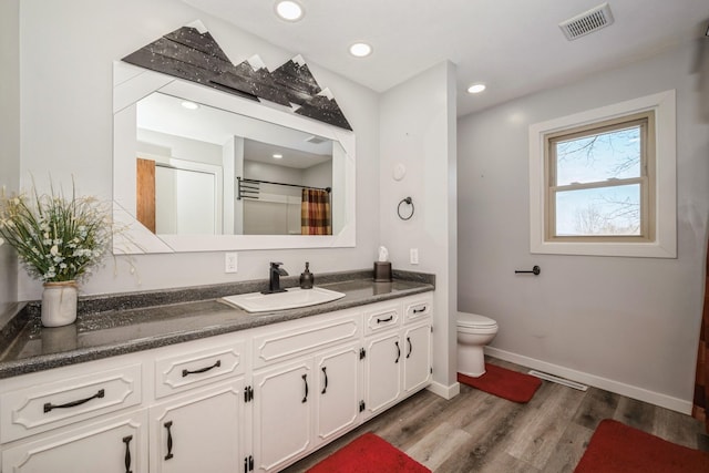 full bathroom featuring visible vents, toilet, wood finished floors, recessed lighting, and vanity