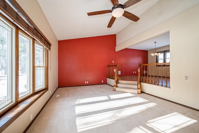 unfurnished room with baseboards, a notable chandelier, vaulted ceiling, and carpet