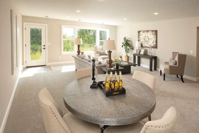 sitting room with recessed lighting, light colored carpet, and baseboards