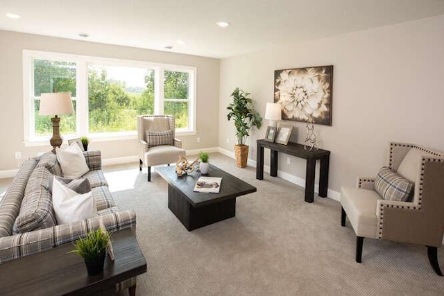 living room with recessed lighting, light colored carpet, and baseboards