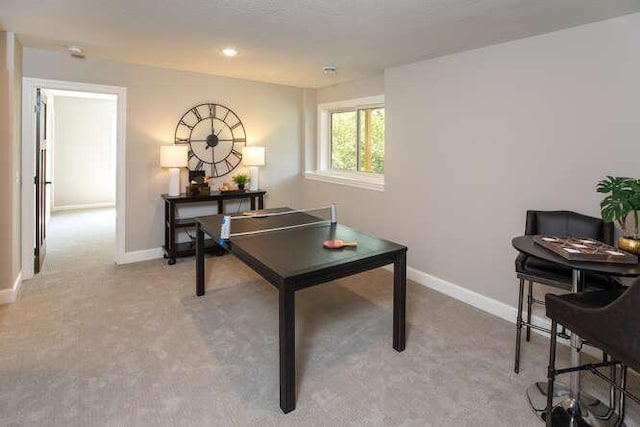 recreation room with recessed lighting, light carpet, and baseboards