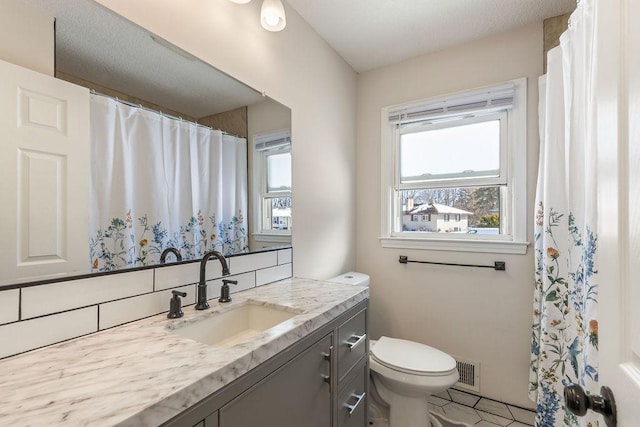 full bathroom featuring toilet, visible vents, decorative backsplash, and vanity