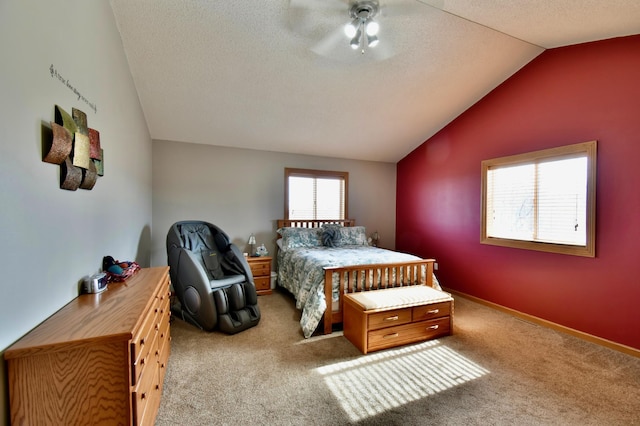 carpeted bedroom with ceiling fan, lofted ceiling, baseboards, and a textured ceiling