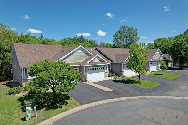 15436 70th Ave N, Maple Grove, MN 55311 - view of front of house featuring an attached garage, driveway, stone siding, a shingled roof, and a front yard