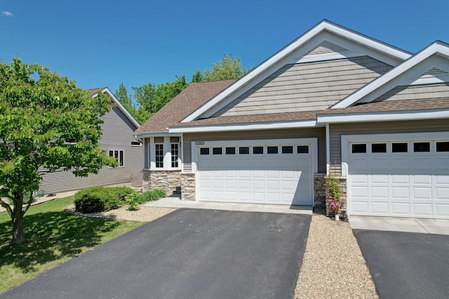 15436 70th Ave N, Maple Grove, MN 55311 - view of front of property with stone siding, a shingled roof, asphalt driveway, and a garage
