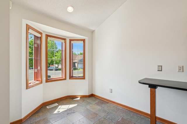 15436 70th Ave N, Maple Grove, MN 55311 - empty room featuring baseboards, stone tile flooring, and recessed lighting