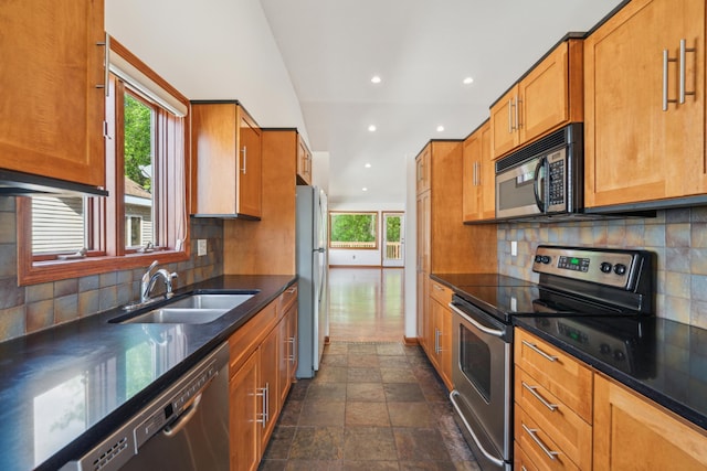 15436 70th Ave N, Maple Grove, MN 55311 - kitchen with appliances with stainless steel finishes, a sink, recessed lighting, stone finish flooring, and brown cabinets