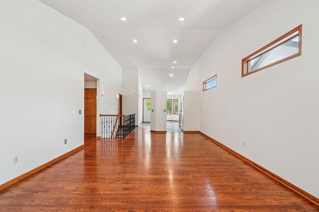 15436 70th Ave N, Maple Grove, MN 55311 - unfurnished living room featuring wood finished floors, recessed lighting, baseboards, and high vaulted ceiling