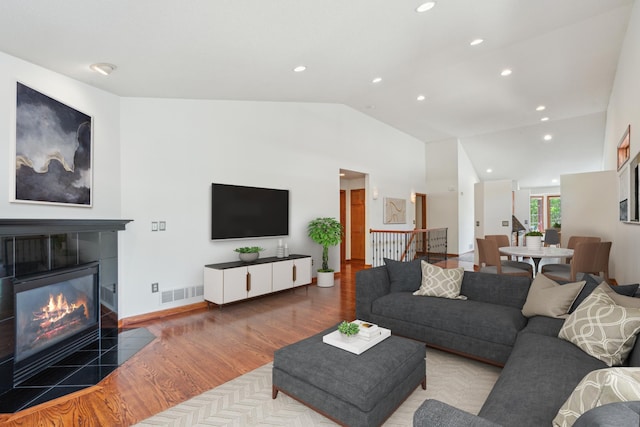 15436 70th Ave N, Maple Grove, MN 55311 - living room featuring wood finished floors, vaulted ceiling, recessed lighting, and a tile fireplace