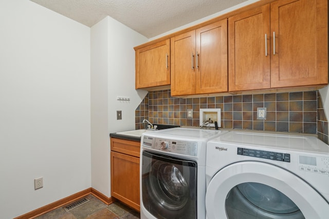 15436 70th Ave N, Maple Grove, MN 55311 - laundry area featuring separate washer and dryer, baseboards, cabinet space, and a textured ceiling