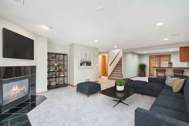 15436 70th Ave N, Maple Grove, MN 55311 - living room featuring stairs, recessed lighting, baseboards, a tiled fireplace, and carpet flooring