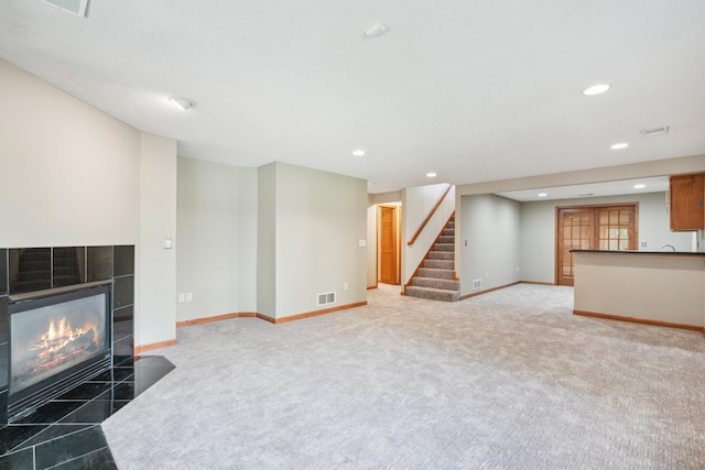 15436 70th Ave N, Maple Grove, MN 55311 - unfurnished living room featuring recessed lighting, stairway, baseboards, carpet, and a tiled fireplace