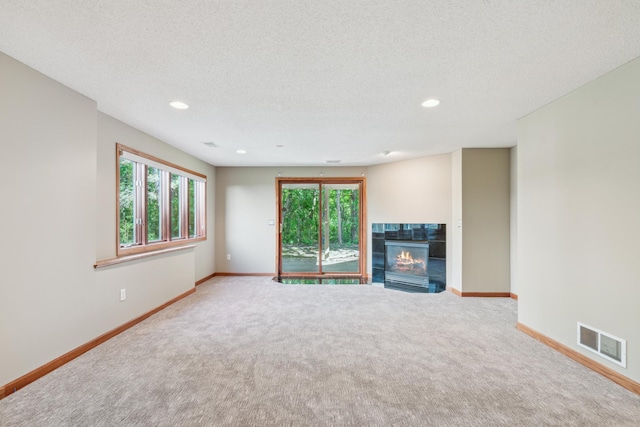 15436 70th Ave N, Maple Grove, MN 55311 - unfurnished living room featuring carpet floors, baseboards, plenty of natural light, recessed lighting, and a textured ceiling