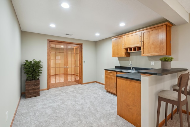 15436 70th Ave N, Maple Grove, MN 55311 - kitchen with french doors, light carpet, dark countertops, a breakfast bar area, and recessed lighting