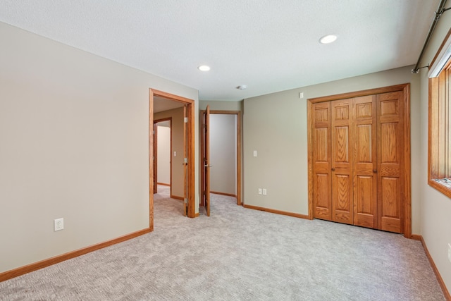 15436 70th Ave N, Maple Grove, MN 55311 - unfurnished bedroom with baseboards, recessed lighting, light carpet, and a closet