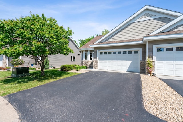 15436 70th Ave N, Maple Grove, MN 55311 - view of front of house featuring asphalt driveway, a garage, and stone siding