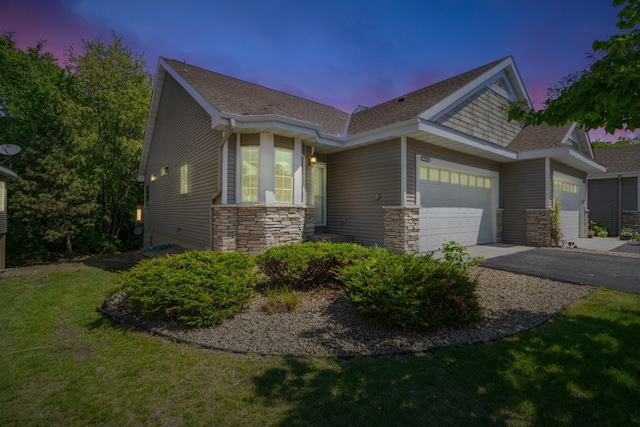 15436 70th Ave N, Maple Grove, MN 55311 - view of front of home with an attached garage, stone siding, a lawn, roof with shingles, and asphalt driveway