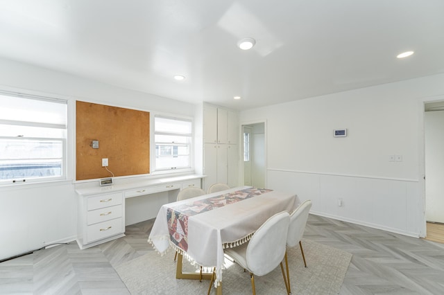 dining area with recessed lighting and a wainscoted wall