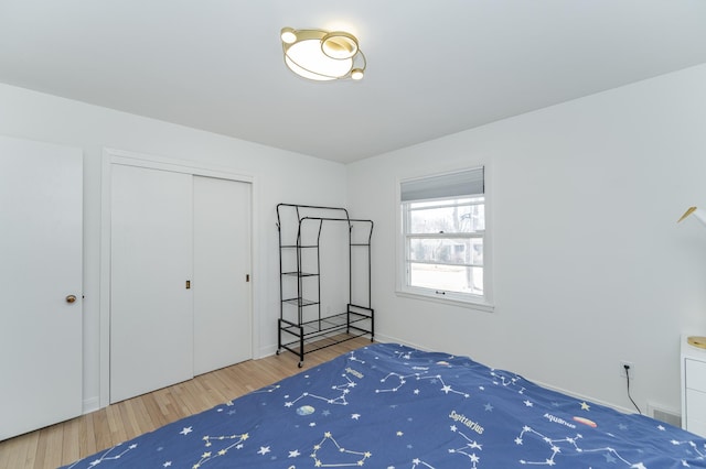 unfurnished bedroom featuring a closet, visible vents, and wood finished floors