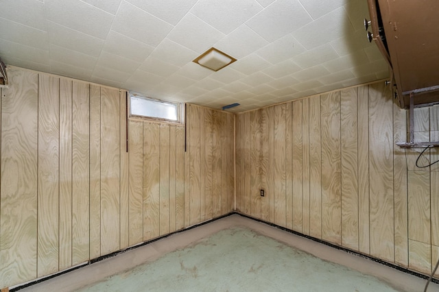 basement featuring wooden walls