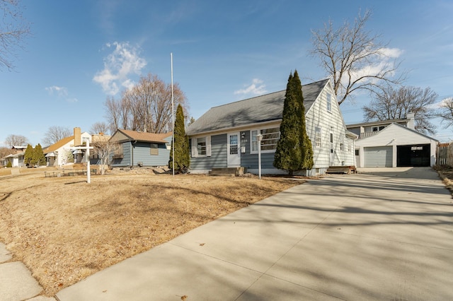 view of front of property with a detached garage, an outdoor structure, and entry steps